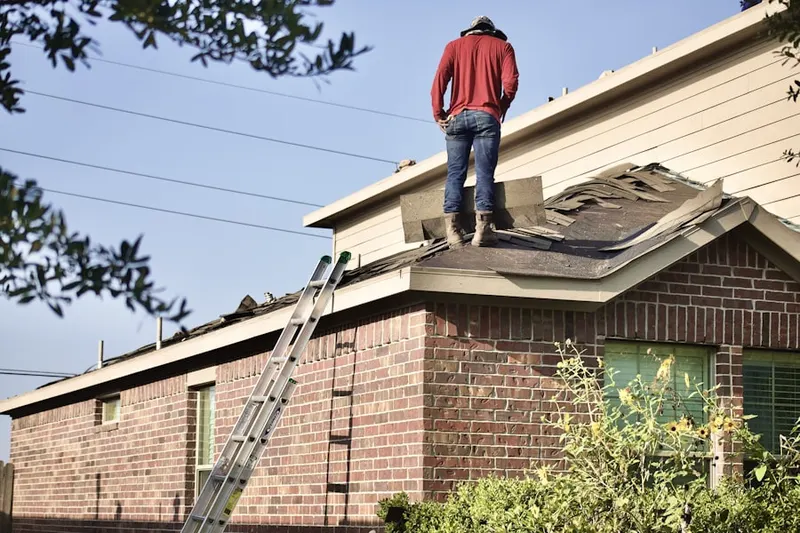 Professional roofer working on a residential roof in Goodrich Heights
